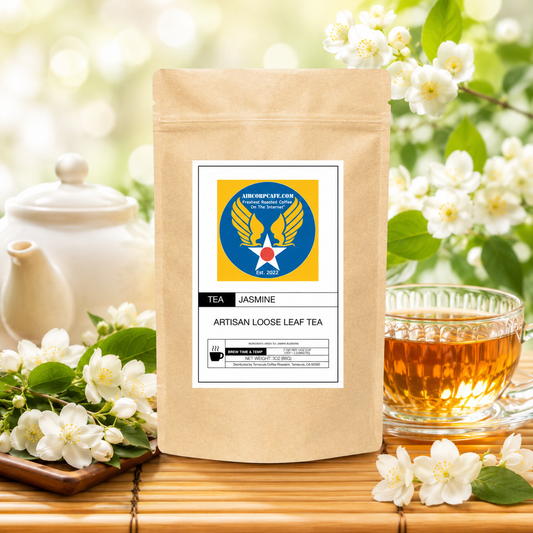 Tea package with a label, teapot, cup of tea, and jasmine flowers on a wooden surface.